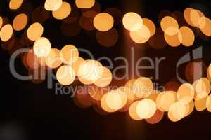 Brighten up your life. Shot of bright lights blurred in the background of a dark setting.