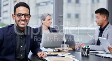 Weve been working on some solid strategies for success. Portrait of a young businessman having a meeting with his colleagues in a boardroom.