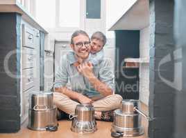 Smiling is definitely one of the best beauty remedies. Shot of a father and son in the kitchen.