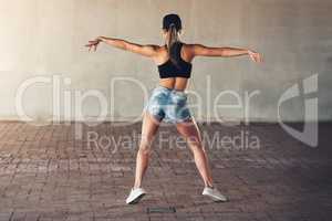 Shes getting her groove back. Rearview shot of a female street dancer practising out in the city.