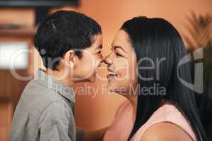 There is tenderness in the love of a mother to a son. Shot of a mother and her little son bonding together at home.