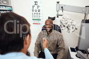 One step away from better eyesight. Shot of a young man having an eye test conducted by an optometrist.