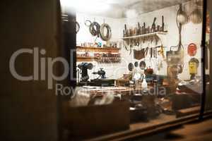 This is my workshop. Shot of a workshop filled with different types of tools inside someones home at night.