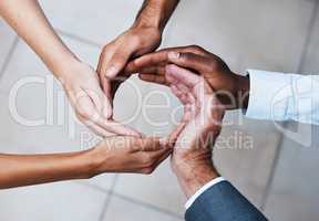 Working together makes productivity flow. Cropped shot of a group of unrecognizable people joining hands in solidarity.
