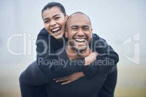 Shes my ultimate supporter. Shot of a young male athlete giving his girlfriend a piggyback ride.