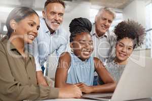 This call will be helpful to everyone. Shot of a group of businesspeople using a laptop at work.