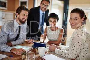 They turn ideas into successes. Portrait of a group of colleagues working together in an office.