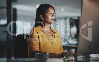 Without some effort, you wont be able to prosper. Shot of a young businesswoman working on a computer in an office at night.