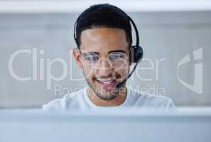 Looking forward to taking the day by the horns. Shot of a young businessman working at his desk in his office.