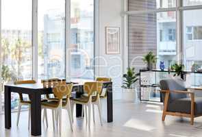 Catch the sun in a room for thoughts. Shot of a well-lit modern office space with nobody in it.