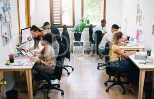 A small office filled with big dreams. Shot of a group of young businesspeople working together modern office.