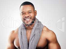 The key to healthy skin is cleanliness. Studio portrait of a handsome young man posing with a towel around his neck against a white background.