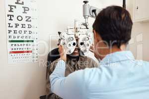 It's always worth seeing an optometrist. Shot of an optometrist examining her patients eyes with an optical refractor.