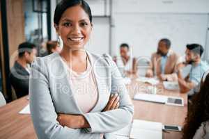 Youre only as strong as your weakest link, and we have none. Cropped portrait of an attractive young businesswoman attending a meeting in the boardroom with her colleagues in the background.