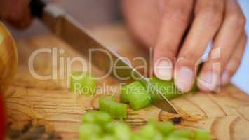 The base of every soup. Shot of a woman chopping up celery.