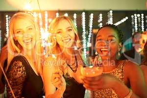 Because a little party never hurt anybody. Shot of a group of girlfriends having fun with sparklers on a night out.