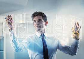 Shot of a young businessman using a cgi digital interface- ALL screen content on this image is created from scratch by Yuri Arcurs team of professionals for this particular photo shoot-this is an alternative version to iStock file 44832592