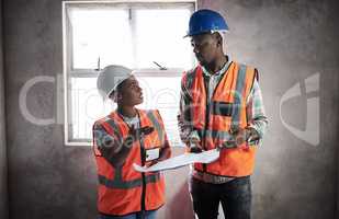 Plan, create, construct. Shot of a young man and woman going over building plans at a construction site.