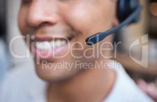 Great things come from hard work. Shot of an unrecognizable businessman sitting alone in his office and wearing a headset.