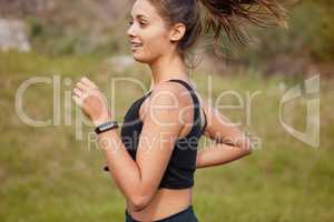 Sprinting straight towards a healthier lifestyle. Shot of a sporty young woman running outdoors.