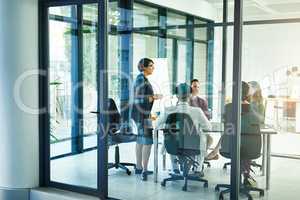 Generating game-changing ideas. Shot of a businesswoman delivering a presentation to her coworkers.