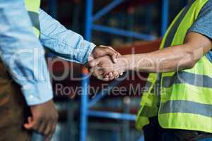 Proud to have a reliable partner like you. Shot of two builders shaking hands at a construction site.