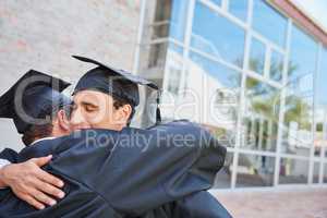 I couldnt have done it without you. Shot of two male students congratulating each other on graduation day.