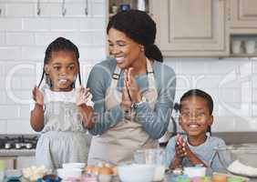 Baking is like washing, the results are equally temporary. Shot of a mother baking with her children at home.