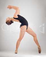 Freedom of movement. Full length shot of an attractive young female ballet dancer in studio against a grey background.