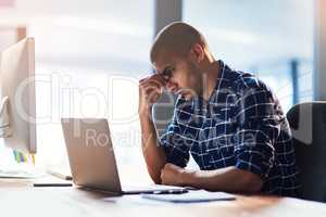 How am I going to get through all these deadlines. Cropped shot of a young designer looking stressed out while working at his office desk.