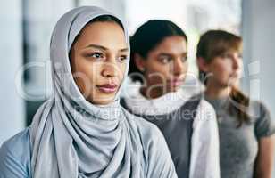 They are certain to succeed. Portrait of a group of young confident businesswomen standing in a row behind each other inside of the office during the day.