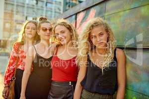 Lined up in the city. Cropped portrait of a group of attractive young girlfriends having a great time out in the city.