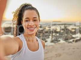 Workout complete. Cropped portrait of an attractive young woman taking a selfie during her workout at the beach.