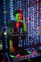 Shes the headline act. Portrait of an attractive young female dj playing in a nightclub.