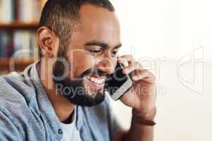 Hi are you free for a chat. Shot of a businessman working from home using his smartphone to make a phone call.