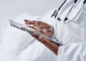 Advancing her skills through digital tech. Closeup shot of an unrecognisable doctor using a digital tablet in a hospital.