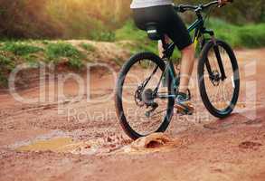 What an exhilarating hobby. Shot of a female mountain biker out for an early morning ride.