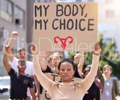 This is my body. Shot of a young woman at a rally holding a placard.