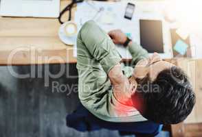 This neck pain doest want to go away. High angle shot of an uncomfortable young businessman holding his neck in pain while being seated in the office during the day.