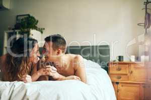 You cant fake that chemistry. Shot of an affectionate young couple spending a romantic morning in bed at home.