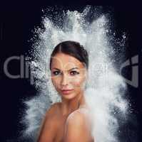 What a burst of beauty. A young woman with bare shoulders being enveloped by a burst of white powder.