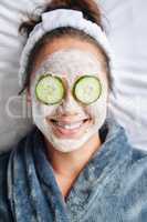 At home spa day. Shot of a young woman lying down with a beauty facial treatment on her face.