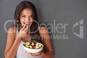 Nibbling on the best parts of her salad
