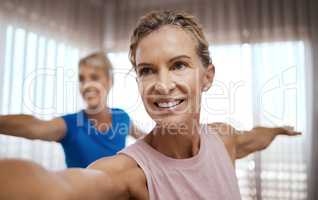 The person judging you is probably not your soulmate. Shot of two mature women exercising together at home.