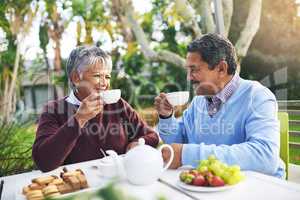Retirement done right. Shot of a happy older couple having tea together outdoors.