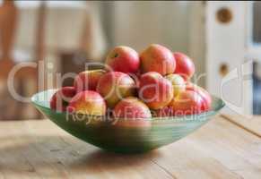 An apple per day keeps the doctor away. Glass bowl with lots of healthy apples - a really healthy and tempting treat..