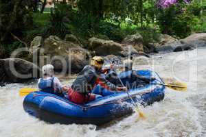 Nature will offer some of the best adventures. Shot of a group of young male friends white water rafting.