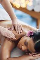 Permit yourself to pause. Shot of an attractive young woman getting a massage at a spa.