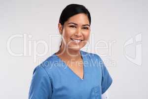 Medicine cures disease, doctors cure people. Portrait of a young beautiful doctor in scrubs against a white background.