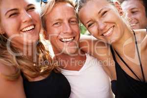 Surrounded by sweet smiling. A group of smiling friends enjoying each others company.